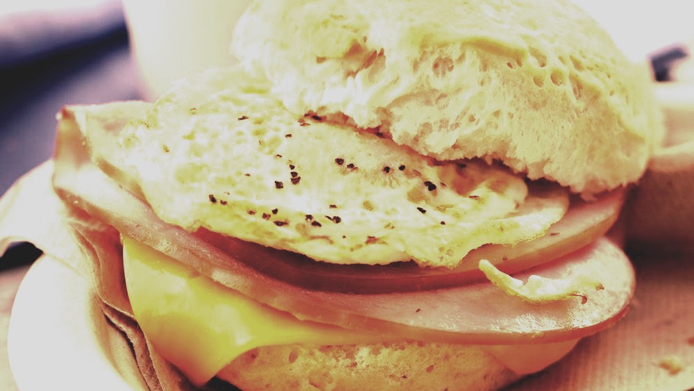 >|Seventh step: Place the meat on the sandwich and stick it together. Spray the skillet again, or melt a little butter, to finish melting the cheese hasn't melted all the way yet. It should have with the meat being placed onto it and earlier when you put it over the warm egg and bread.