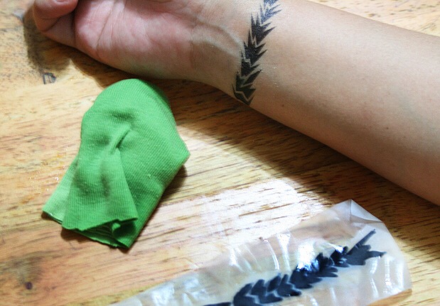 Step 6: Once it is done, remove the rag and peel off the paper. Let the design air dry as much as possible, taking care not to brush it against clothing or other parts of your body. Enjoy!