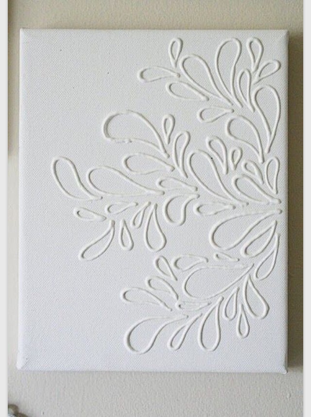 Use a hot glue gun or Elmer's glue to put a design on a canvas then paint over the whole canvas in one colour. 