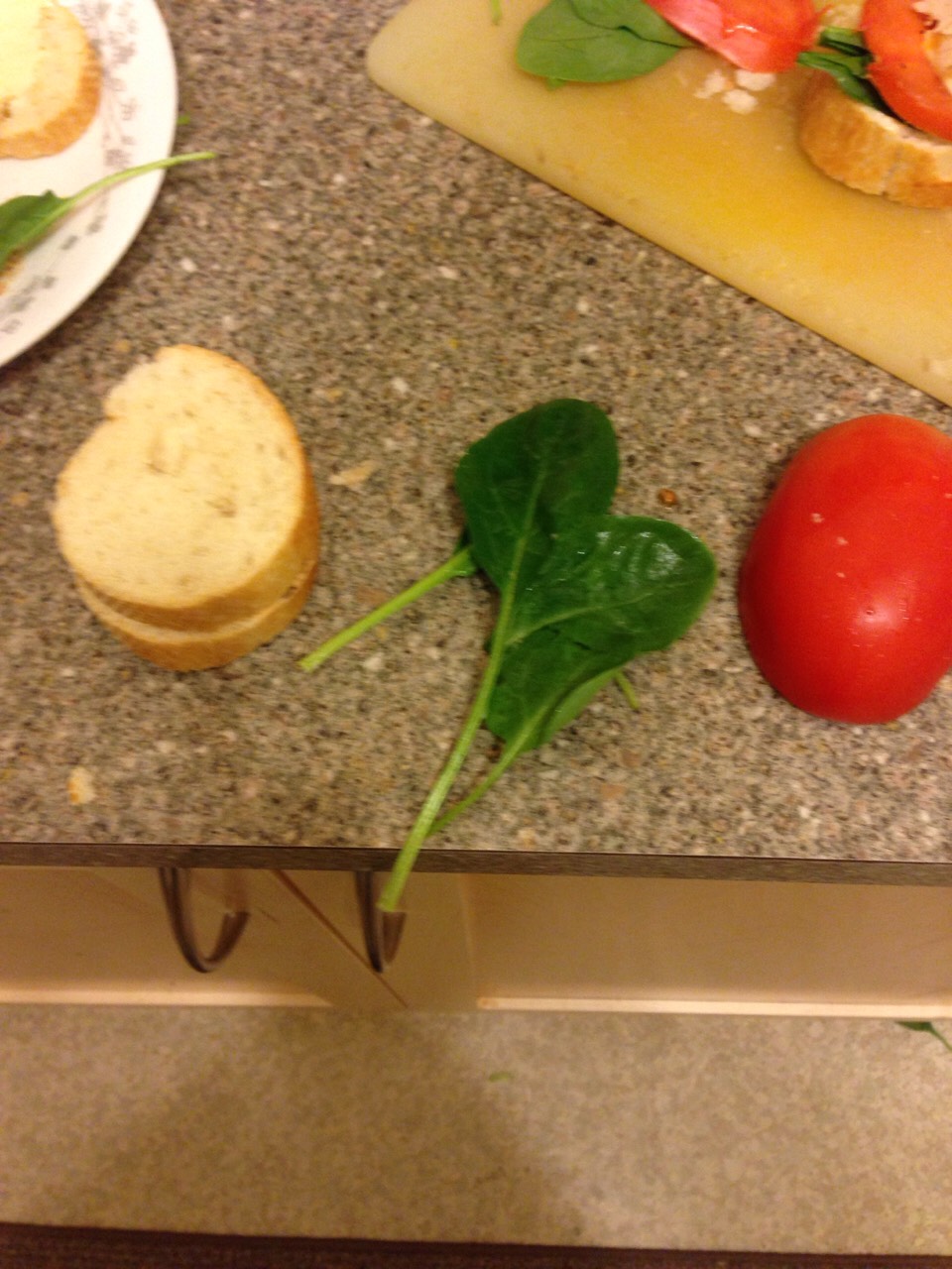 Ingredients:
2- 4 baby spinach  leaves per baguette piece.
1 tomato
1 baguette