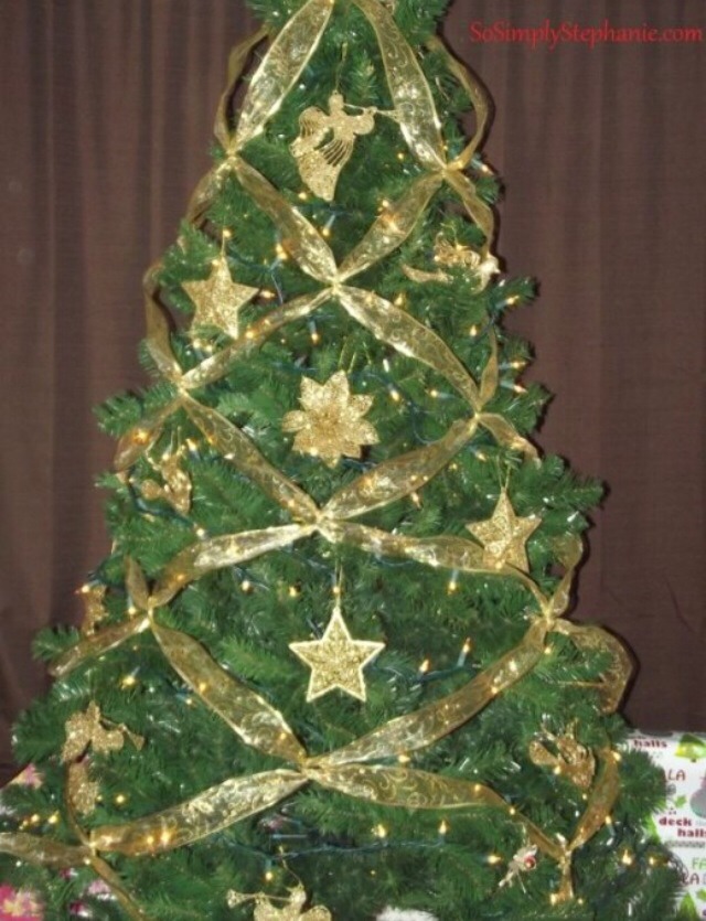 Once you have criss crossed the ribbon to the bottom of your Christmas tree you are almost finished. You can either cut the excess ribbon off and tuck the end into the tree or make a final criss cross between the sections, cut off the ends and tuck it.