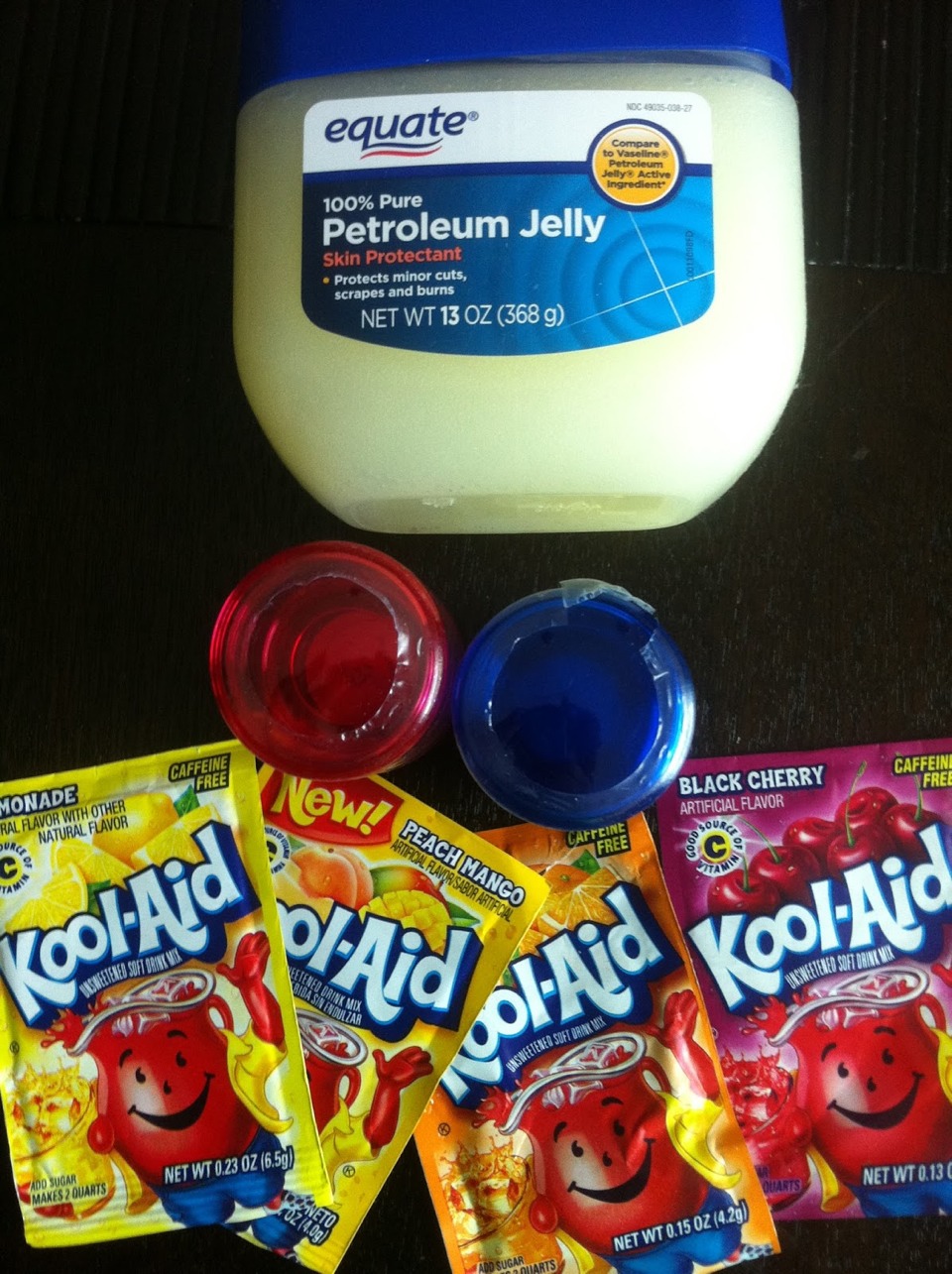 Kool aid lip balm:   take as much Vaseline as you like and heat in 30 second increments stirring in between. Continue to do this until Vaseline is completely liquid. IT WILL BE HOT. Stir in kool aid until desired colour. Reheat if it solidifies. Let cool 2 hours before using. 