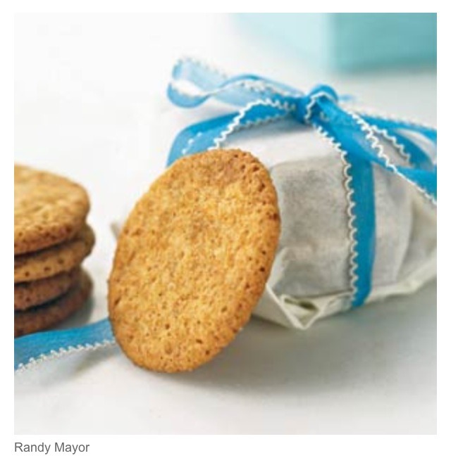 Wrap cookies in wax paper, secure with a ribbon, and tie a cookie cutter to the ribbon.