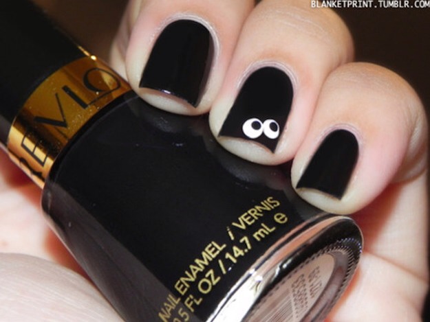 8. Super Simple Spooky Nails
Start with a coat of black, then use two different-sized dotting tools (like a Q-tip and a thin water-based Sharpie) for an easy accent nail. 