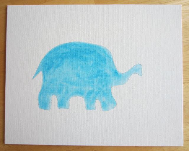 To make this cute little elephant, all you need are some buttons, hot glue, a wee bit of paint, a canvas board (which you can find at any craft store) and a frame.