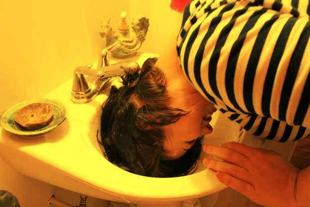 10. If you have especially thick hair that takes forever to dry, try “half-washing it” in the sink.
Most of the oil begins with the scalp, so you're washing away the grease that's causing the flatness in half the time! This trick is also great if you get greasy bangs.