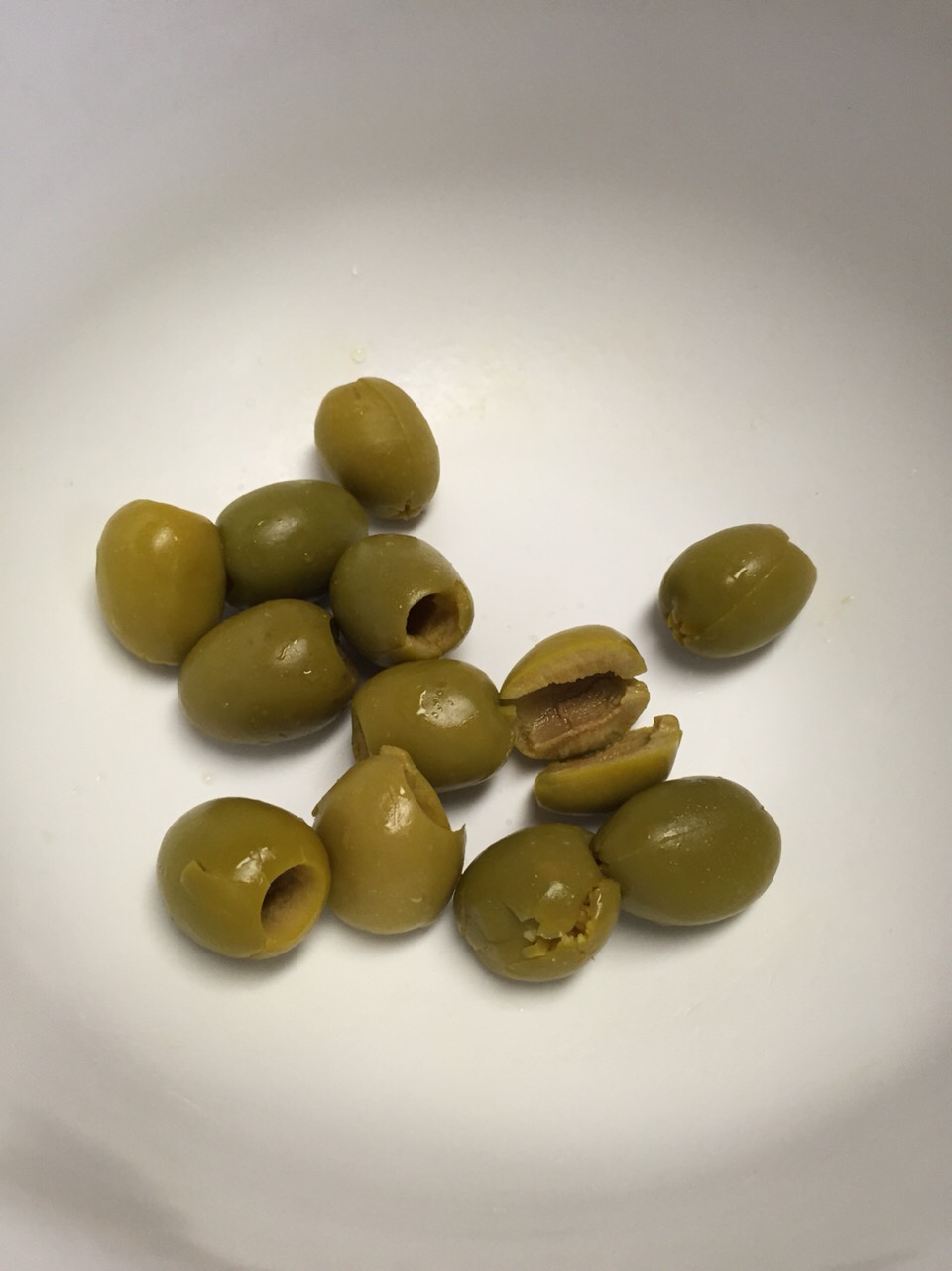 Slit olives until all jars are done and ready to be stuffed. 