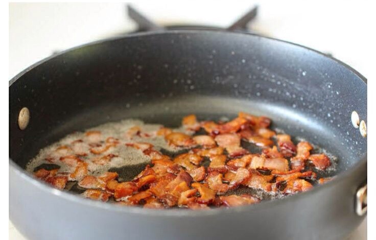 First chop 4 slices bacon and fry until golden colour, add four chopped garlic cloves
