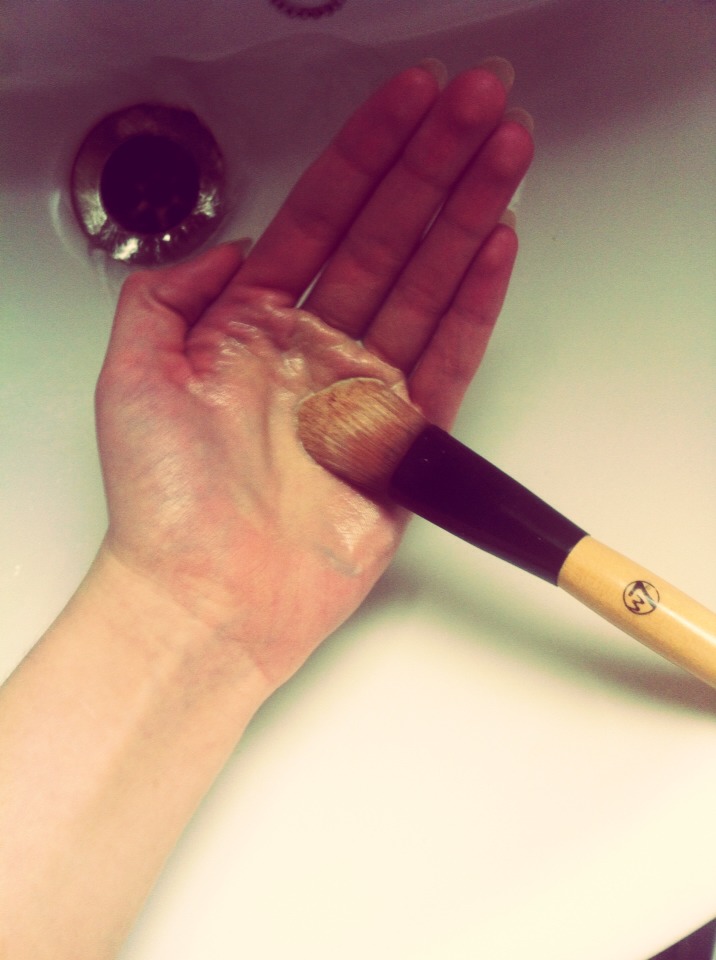Swirl the dirty brush around the palm of your hand so it lathers with soap. You'll be able to see the makeup coming off the brush and changing the colour of the soap suds.