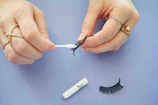 22. Apply eyelash glue to false lashes with the tip of a clean cotton swab or bobby pin.