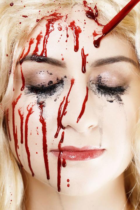 14. Apply fake Blood:- Dip a coffee stirrer or spoon into a cup of fake blood and dribble it onto your forehead, allowing the drips to run down your face.