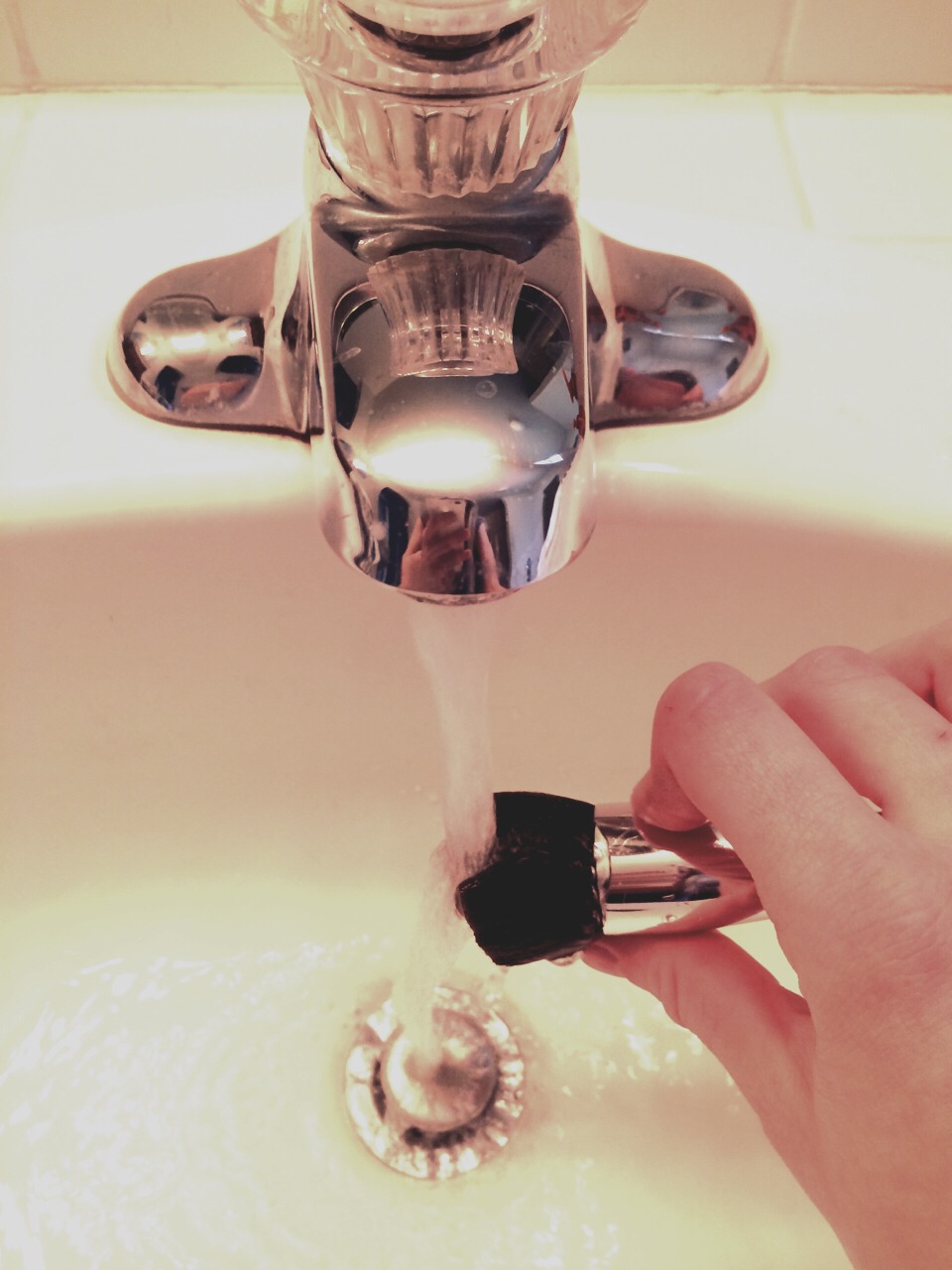 Rinse out the soapy makeup, but as the ladies at bare minerals told me, try not to get the water up inside the handle where the bristles are connected. The glue over time will start coming off.