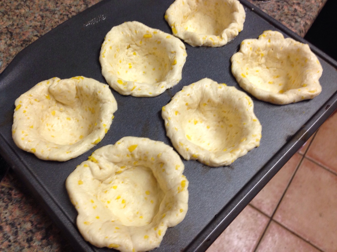 Press the biscuits into a muffin tin and follow package cooking directions.