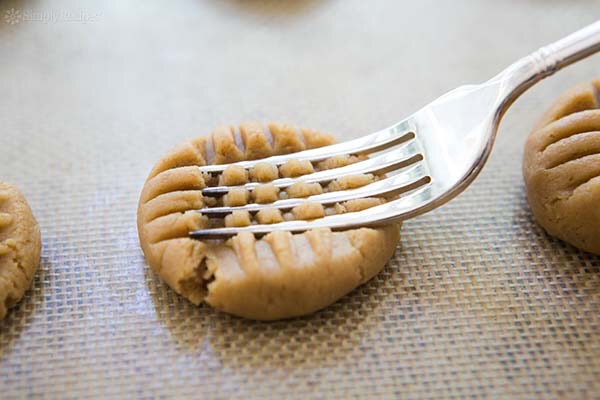 Then, take a fork and GENTLY push the cookies down vertically and horizontally. 