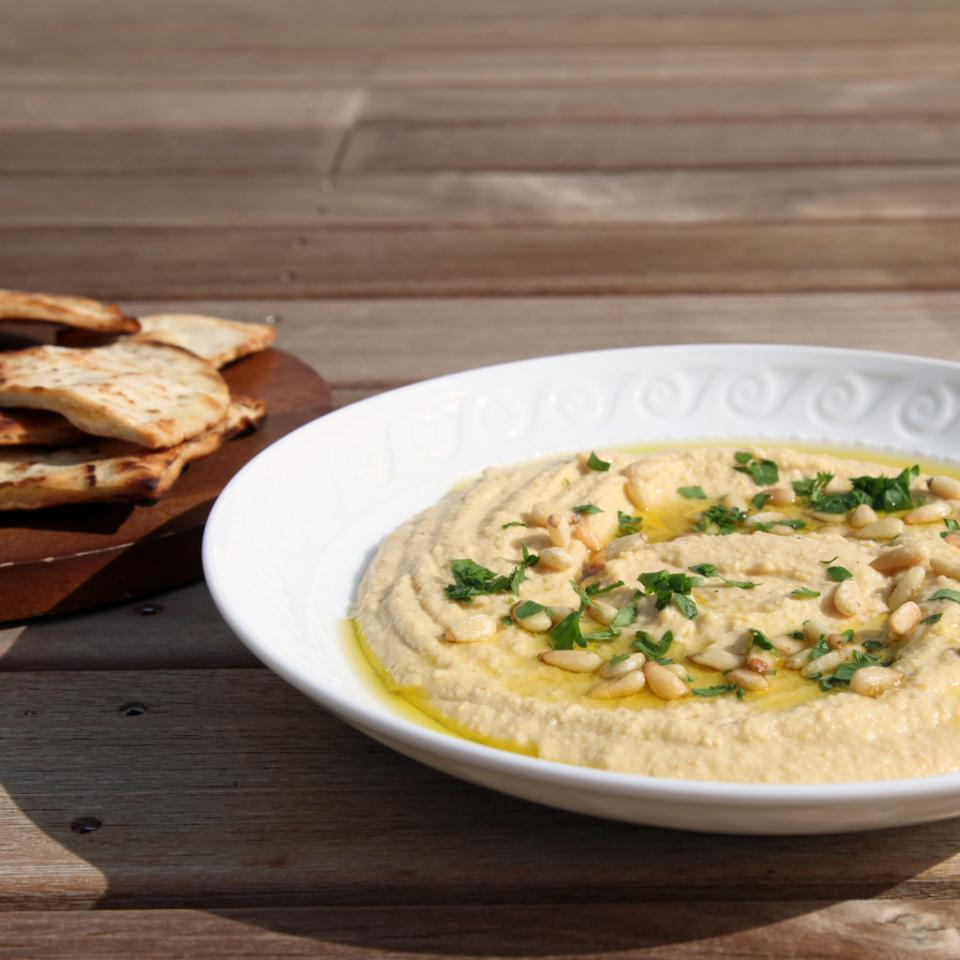 1. Hummus
Keep hummus in your fridge, and you'll never have to opt for an unhealthy snack again. You can smear the protein-packed condiment on raw veggies, serve it atop salad greens, or use it in place of mayo on a sandwich — saving tons of calories in the process.