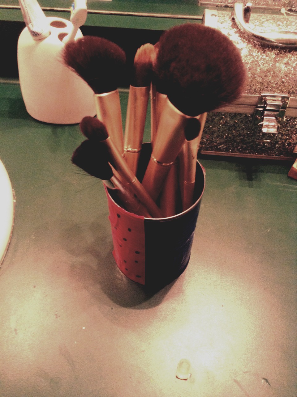 Use a spare can and spray paint it or put duck tape on it. Then put some beads in it and create and awesome brush holder! 
