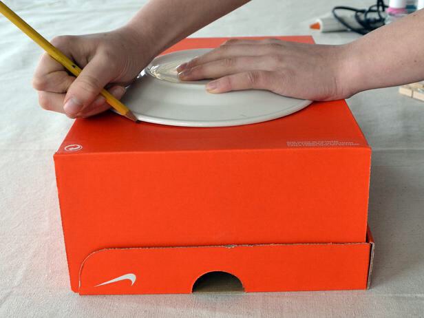 Grab a plate with a size of your choice put it onto the shoe box and draw around it😁