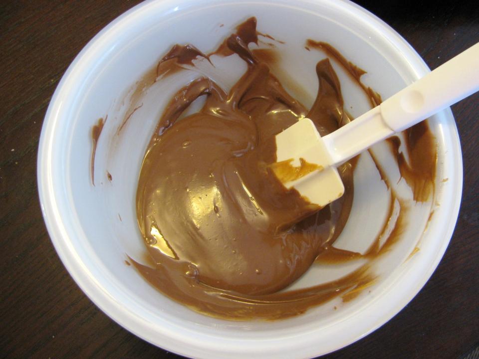 Heat in microwave 30 seconds and stir.  Continue to heat at 30 second intervals until completely melted