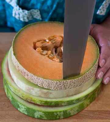 Stack two ¾” thick slices of watermelon, one ¾” thick slice of cantaloupe, and one ¾” thick slice of honeydew on top of each other, and cut inside the rind of the smallest round, creating four pieces of melon that are uniform in size.