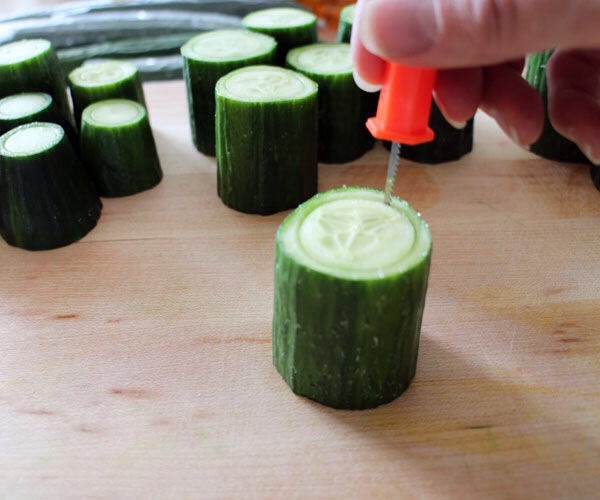 Use your tiny pumpkin carving knife or paring knife to cut into the cucumber segments following the circle guides, being careful not to go all the way through! Try to leave a bottom (floor) of at least 1/4".
