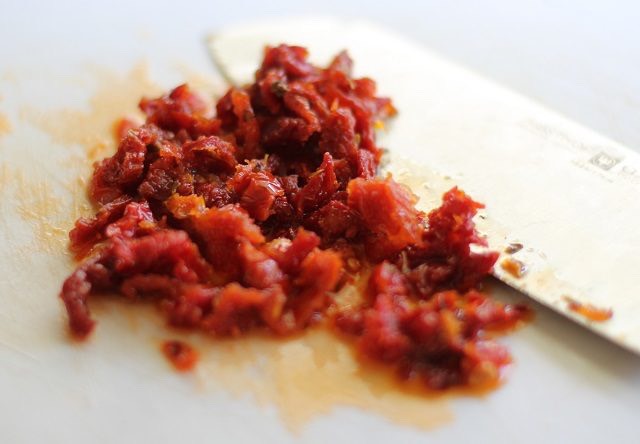 Step 2: Make the Filling

Use a paper towel to dab some of the oil from the sun-dried tomatoes before placing them on a cutting board and chopping them.