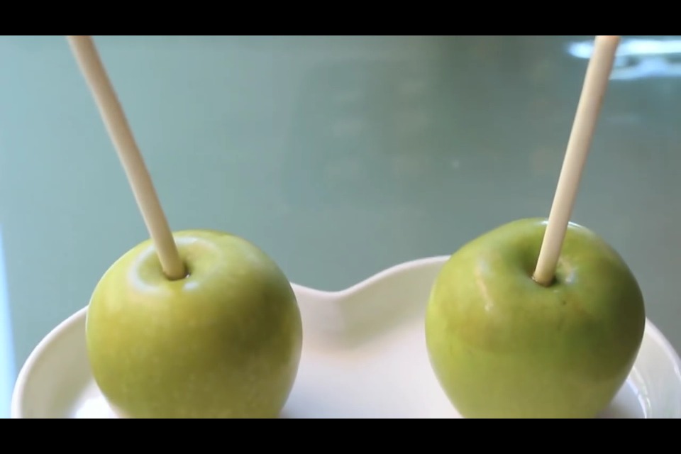 Place wooden stick halfway into apple