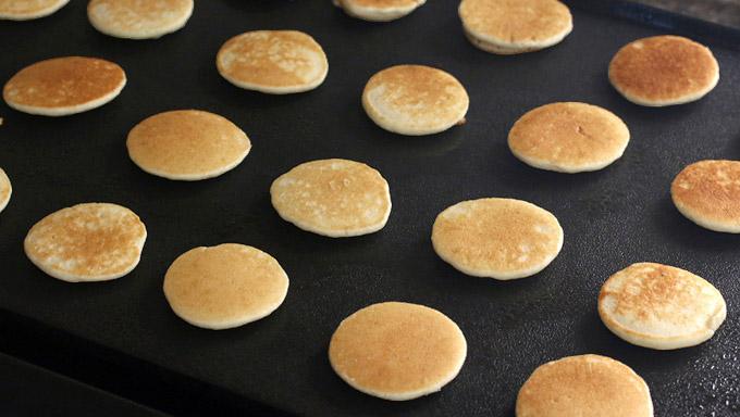 Cook the mini pancakes for about a minute on each side or until lightly browned.