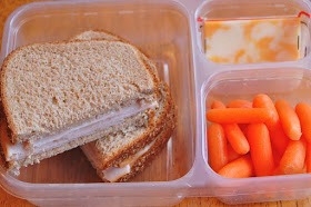 turkey on whole wheat bread, cheese, carrots
