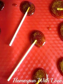 This is what the mixture looks like  spoon'd onto the nonstick pad and lollipop sticks placed.
Since we did not use a mold, sometimes the mixture moved more than others. We like the fact that when that does happen it is all the more homemade looking and perfectly fine.
