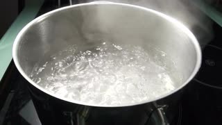 When water is boiling under the bowl, pour all of the beeswax and coconut oil in the bowl.