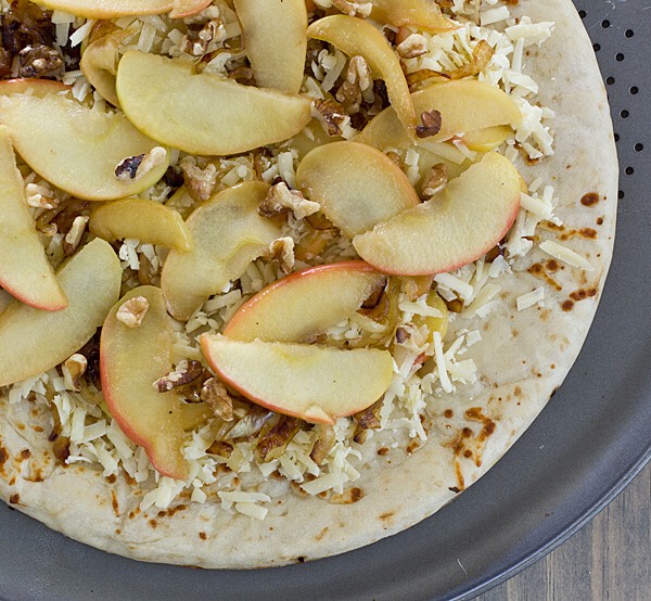 30. Apple-Cheddar Stretch dough into two thin 9-inch rounds. Brush each with olive oil and season with salt; top with 1 sliced apple, 1 teaspoon fresh thyme and 1 cup shredded cheddar. Bake until golden; top with crumbled bacon and maple syrup.