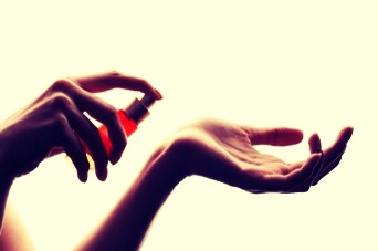 Dab some vaseline onto your wrist before spraying to make it last longer.