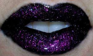 5. Using the clear lipglass and the lip brush, gently paint the gloss thickly over your lips. Again, do not rub your lips together. Done properly, this creates a very slick, sparkly look.