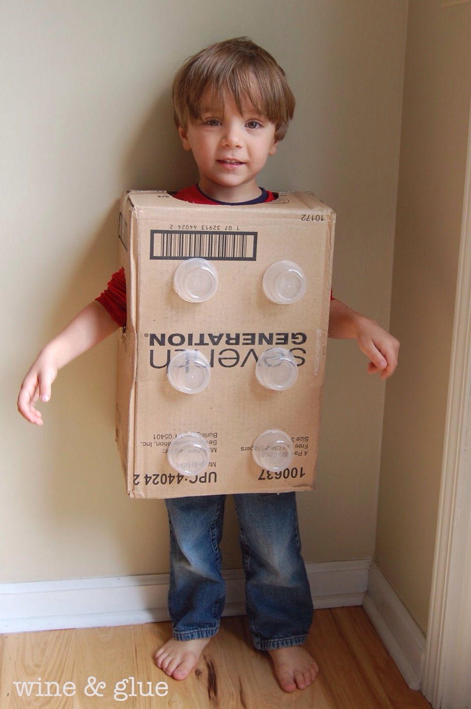 Grab a old box.
Some yoghurt pots
Stick them on.
DIY Lego cube.