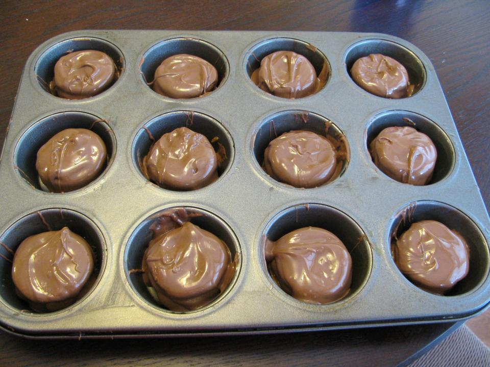 
 Spoon the melted chocolate over the tops and let it run down the sides to completely cover each one.  Then put in the refrigerator for at least an hour.  I just went around each one with a knife and they popped right out.Enjoy!