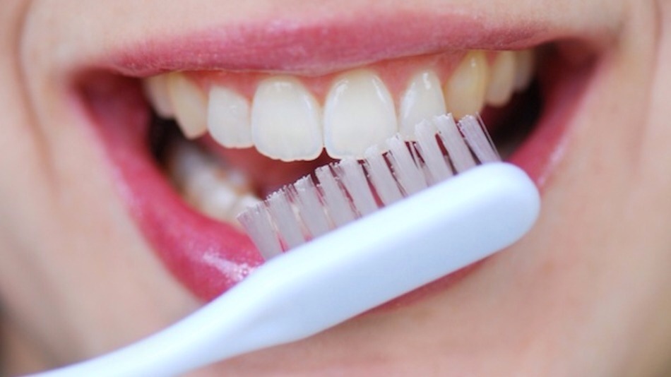 Brush your teeth with a toothbrush and regular toothpaste. Strawberries contain an enzyme called Malic acid that removes stains. 