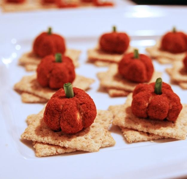 Pumpkin Cheese Balls

Coat a cheeseball with paprika, and garnishe with a little piece of scallion green. 

http://thegirlsofgourmetcooking.blogspot.ca/p/appetizers.html