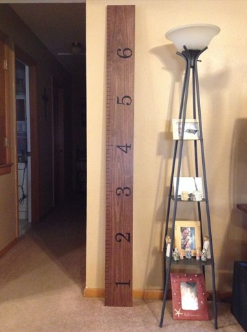 Huge measuring ruler made from a simple scrap of wood for measuring the child's growth.