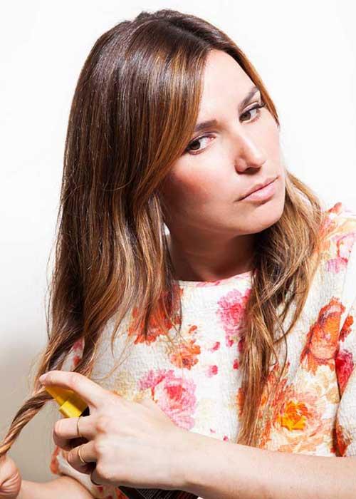  I divide my hair into four sections. I then spritz my hair twice with Banana Boat Tanning Oil and then twirl my hair, working the oil in. I keep twirling until my hair dries, which gives it a natural, second-day look."