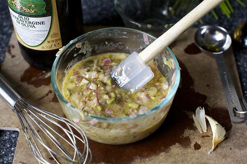 Make the dressing: Place the chopped shallot and red wine vinegar in the bottom of a small bowl and let sit for 5 minutes. Whisk in minced garlic, dijon, a pinch of salt, a few grinds of black pepper and olive oil. Stir in chopped capers, cornichon and scallions.