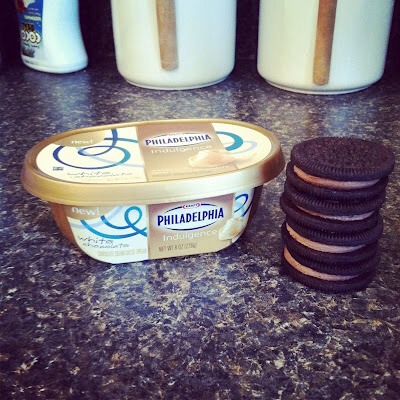Remove the top of the cream cheese packages and place in the microwave for about 30 seconds to warm it up. In a large mixing bowl, beat the cream cheese until creamy. Fold in 3 cups Cool Whip. Divide the mixture in half and place in two bowls. Chop up enough cookies to make 5 cups. 