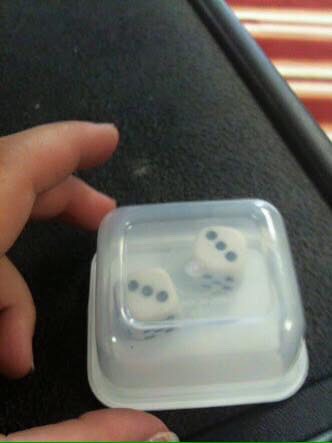 Put dice in a small see through container so it won't get lost 