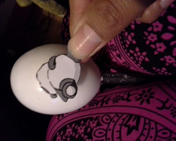 3. Choose any image you like and cut it. Glue it to your egg and brush it with glue for the last time.