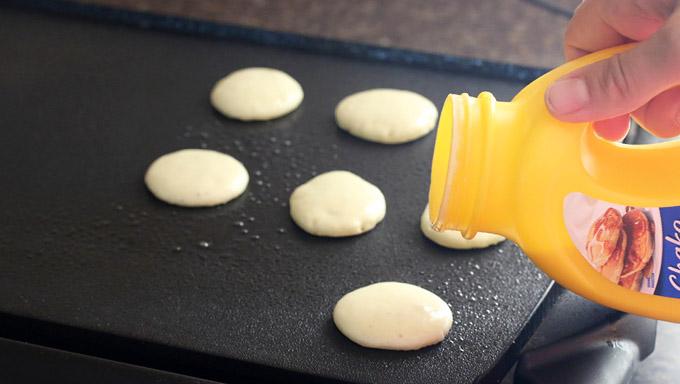 To make this super easy, use Bisquick Shake ‘n Pour Buttermilk pancake mix and prepare the batter according to package directions. Pour small dabs of batter onto a hot, lightly greased griddle to achieve the size of about 1 1/2 inch diameter pancakes (about 3/4 tablespoon of batter per mini pancake)