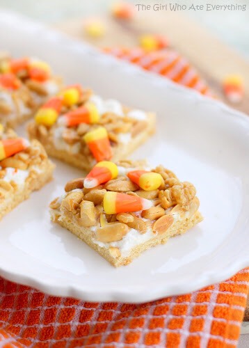Stir in cereal and peanuts. Mixture will be thick. Immediately spoon over marshmallows and spread to cover. I pressed the mixture down into the marshmallow. Quickly sprinkle the candy corns on top and press them down into the bars. Cool completely. Cut into small bars.