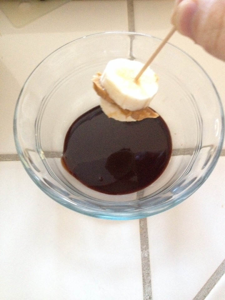 Dip banana into the chocolate until covered