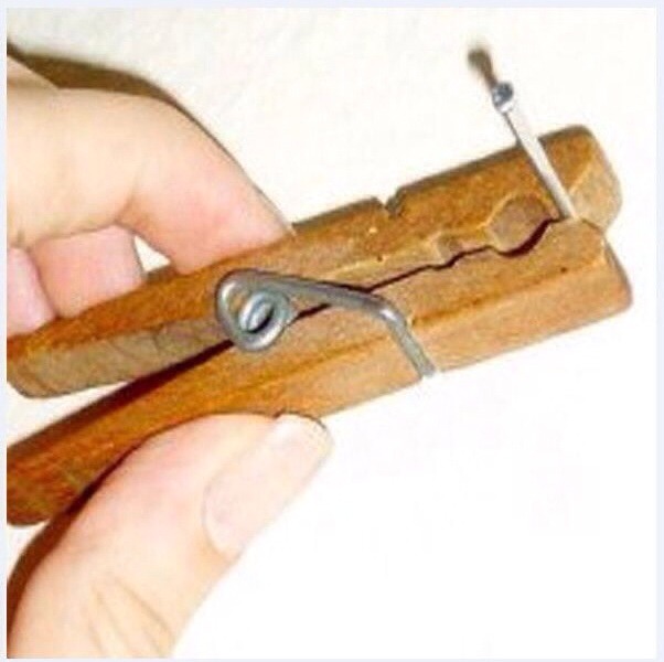 Use a clothing peg to hold a nail while hammering