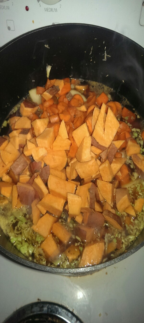 next I add the diced sweet potato yellow potato and carrots into the boiling broth 