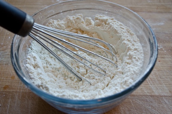 Combine ground cinnamon, ground nutmeg, ground cloves, all-purpose flour, sugar, and baking powder in a separate bowl and mix