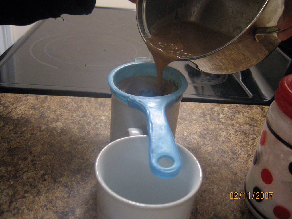 Filter the tea mixture in a coffee cup. 